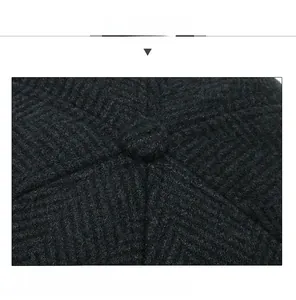Macro shot of the spiral stitching process on the crown of a black winter wool cap