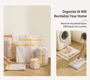 Mesh laundry bags set with bear print and yellow zippers shown next to a washing machine