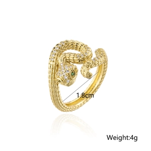 Bohemian gold snake ring with green stone eyes and shimmering zircon pavé details