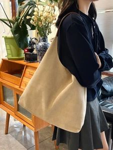 Minimalist beige faux suede tote bag with brown leather strap for casual commute