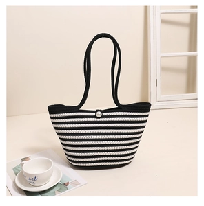 Close-up of striped woven cotton tote bag featuring an elegant pearl button closure