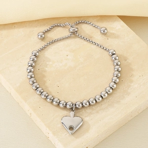 Macro view of adjustable silver steel bead bracelet with a polished heart charm