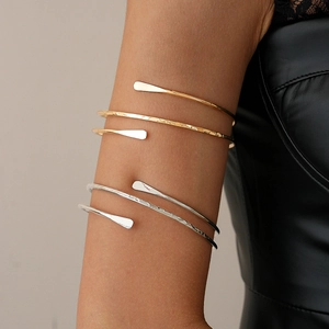 Dual-layer minimalist metallic upper arm cuffs in polished gold and hammered silver finishes