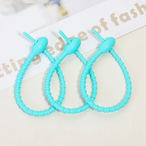 Detail view of three Tiffany blue silicone cable ties on a minimalist background