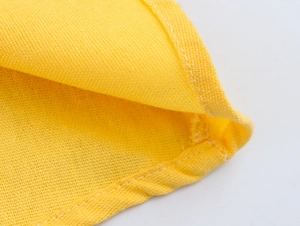 Detailed macro shot of yellow linen-textured fabric with durable double-stitched seams