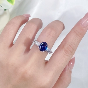 Minimalist S925 sterling silver ring with oval tanzanite purple gemstone on a finger