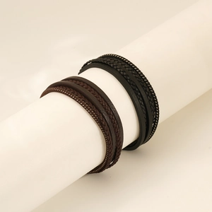Detail of multi-layer handcrafted leather bracelets in brown and black for men
