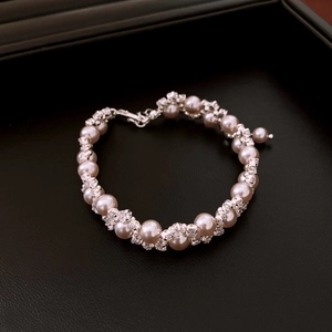 Detail of elegant pearl bracelet with crystal spacers on a dark luxury display