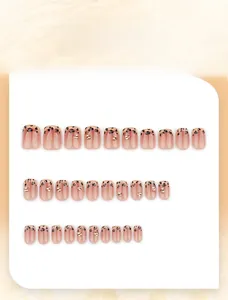 Detailed view of 30pcs nude pink press-on nails with leopard print and gold rhinestones