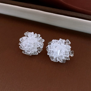 Detailed close-up of crystal cluster stud earrings with white multi-faceted beads