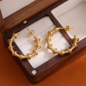 Modern 18K gold-plated C-shaped hoop earrings with spiral bamboo texture for women