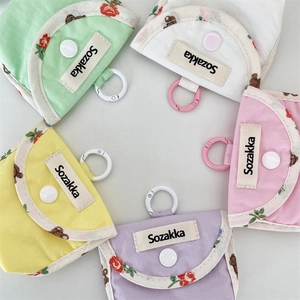 Detailed view of colorful fabric earphone protective cases in a circular layout.