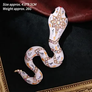 Detail of vintage snake brooch with enamel inlay and colorful rhinestones on black silk
