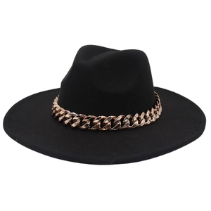 Detail of black wide brim felt fedora hat featuring a chunky rose gold chain decoration