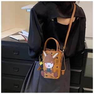 Caramel crossbody bucket bag featuring a cute cartoon rabbit patch and drawstring