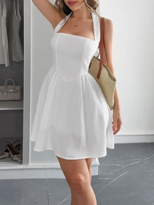 Detail of elegant white halter neck A-line short dress in breathable fabric