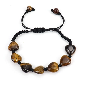 Macro shot of seven heart-shaped tiger eye stones on black braided adjustable bracelet