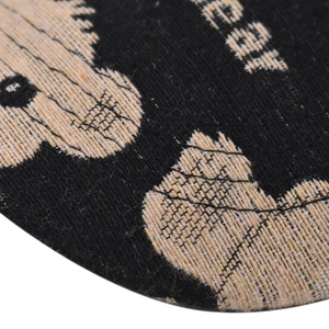 Macro shot of bear baseball cap fabric showing detailed weave and black embroidered pattern