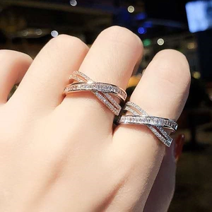 Cross-over X-shaped ring with pavé micro-inlays in rose gold and silver finish