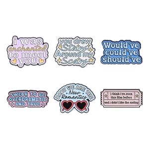 Set of 6 colorful enamel pins featuring creative lyrics on white background