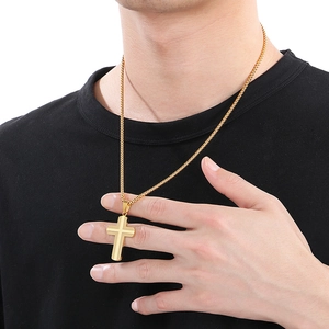 Minimalist golden stainless steel cracked cross pendant necklace worn on a black shirt