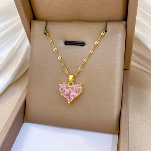 Macro shot of gold-plated titanium necklace with a claw-set pink heart-shaped crystal