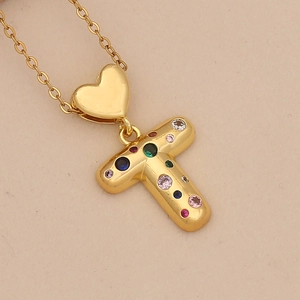 Close-up of golden heart pendant with letter T featuring vibrant colorful zircons