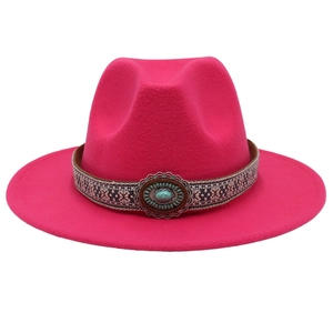 Détail d'un ruban ethnique avec pierre turquoise sur un chapeau fedora en feutre rose