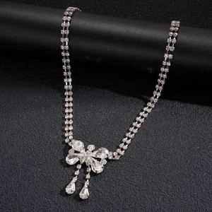 Detail of silver bowknot necklace with sparkling rhinestones and water drop pendants
