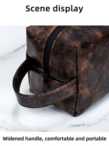 Detail of wide handle on vintage brown PU leather toiletry bag with zipper closure