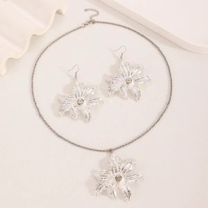 Detailed view of silver lily flower jewelry set featuring sparkling rhinestones
