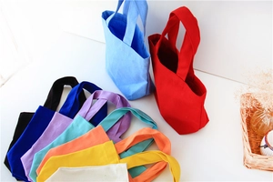 Macro view of multi-color canvas lunch bags showing fabric texture and vibrant tones