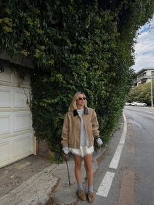 Photo de rue d'une veste décontractée en velours marron avec col noir et jupe en dentelle