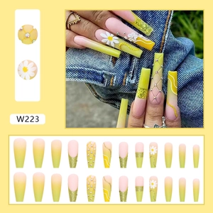Long ballet press-on nails with yellow-pink gradient and cute daisy patterns