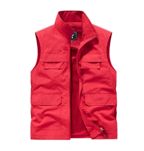 Detail of red outdoor vest showing metal zipper, stand collar and four utility pockets