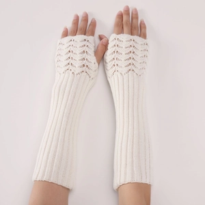 Detail of cream white knit arm warmers with a hollow wavy fish scale pattern