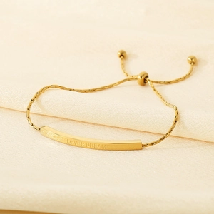 Macro shot of gold-plated adjustable bracelet featuring the Lover Dream engraving