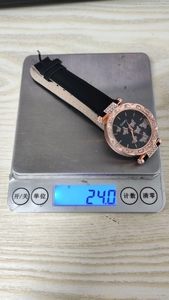 Detailed scale view showing the 24g weight of the butterfly quartz watch for women
