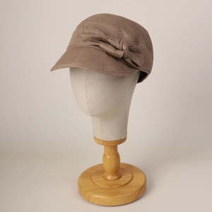 Close-up of dark brown cotton linen baker boy hat featuring a detailed side bow decoration