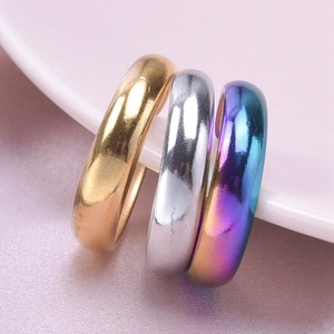 Macro shot of minimalist round rings in gold, silver and colorful finishes