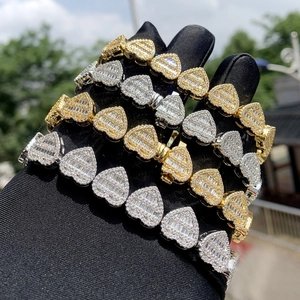 Luxury heart bracelets in gold and silver with pave zircon stones in outdoor light