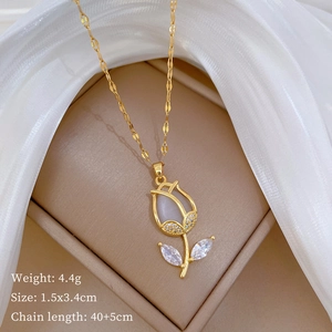 Detailed view of tulip pendant necklace with gems in a gift box with silk background