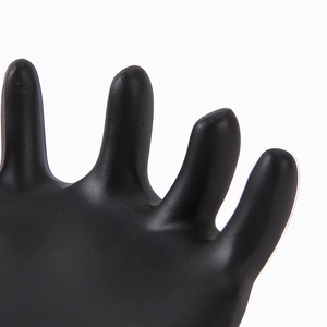 Macro view of matte black resin hand-shaped jewelry tray showing the textured finger detail