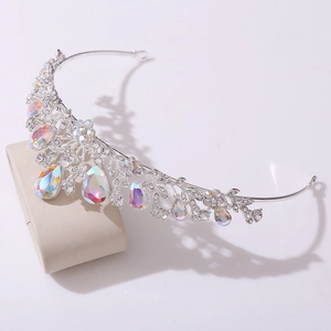 Detailed close-up of a silver bridal tiara with colorful AB rhinestones on a display stand