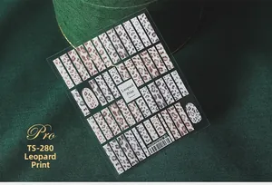 Macro detail of TS-280 leopard print nail stickers on premium dark green velvet background