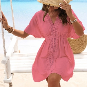 Detail of pink beach cover-up featuring lace trim V-neck and drawstring waist design