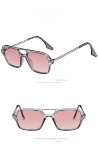 Detail view of transparent grey sunglasses with double bridge and pink lenses