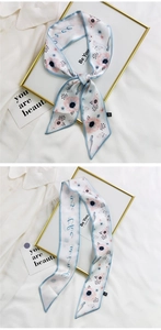 Detail of long silk scarf with blue floral and butterfly print in a satin finish