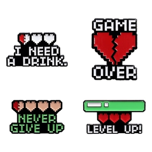 Set of 4 vintage pixel art enamel pins with gaming slogans and life bar heart designs