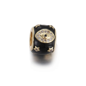 Macro detail of black enamel evil eye charm with gold stars and white zircon accents